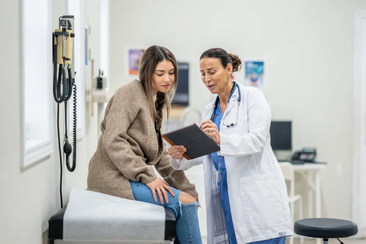 Doctor reviewing notes with a patient